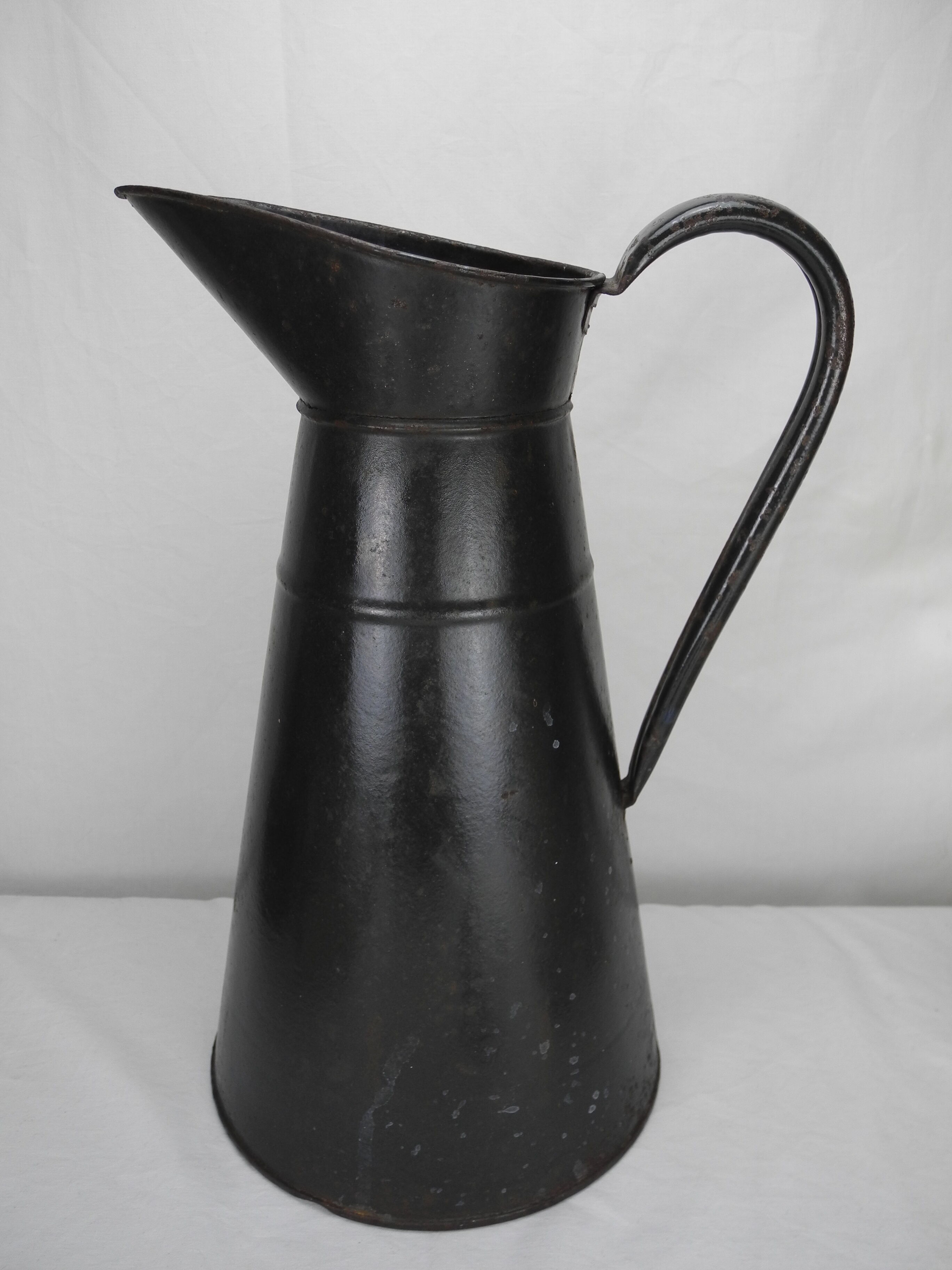 Old enamelled sheet metal jug