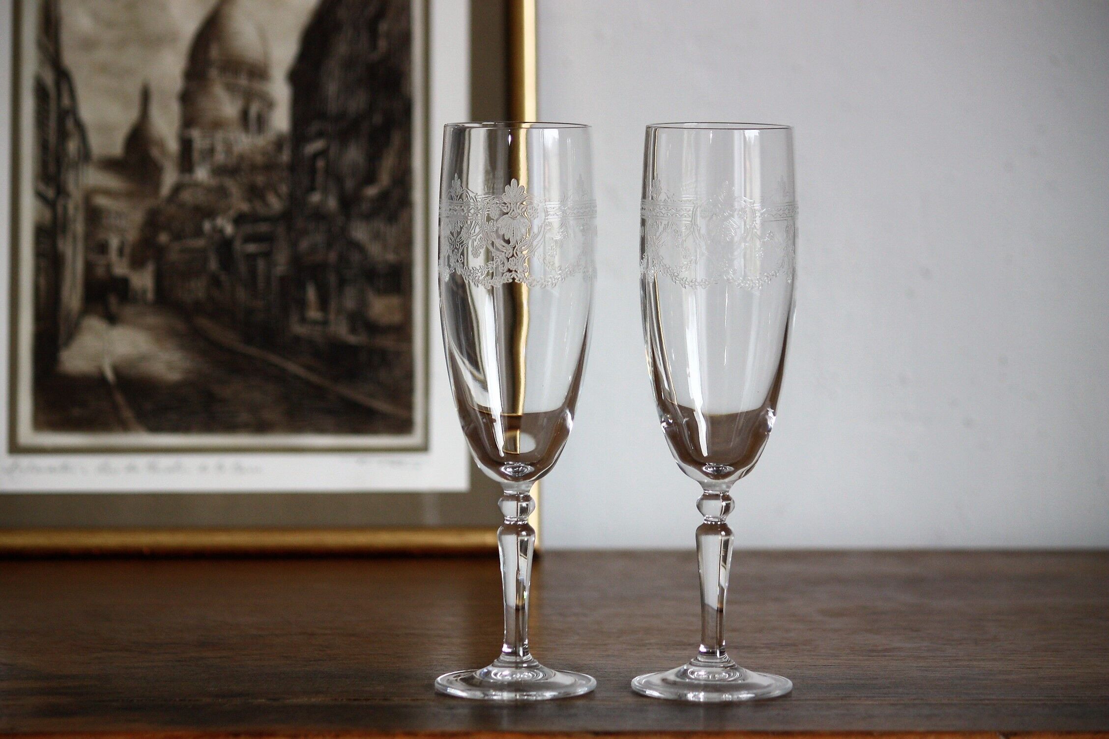 2 crystal champagne flutes of engraved arches
