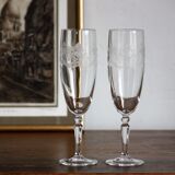 2 crystal champagne flutes of engraved arches