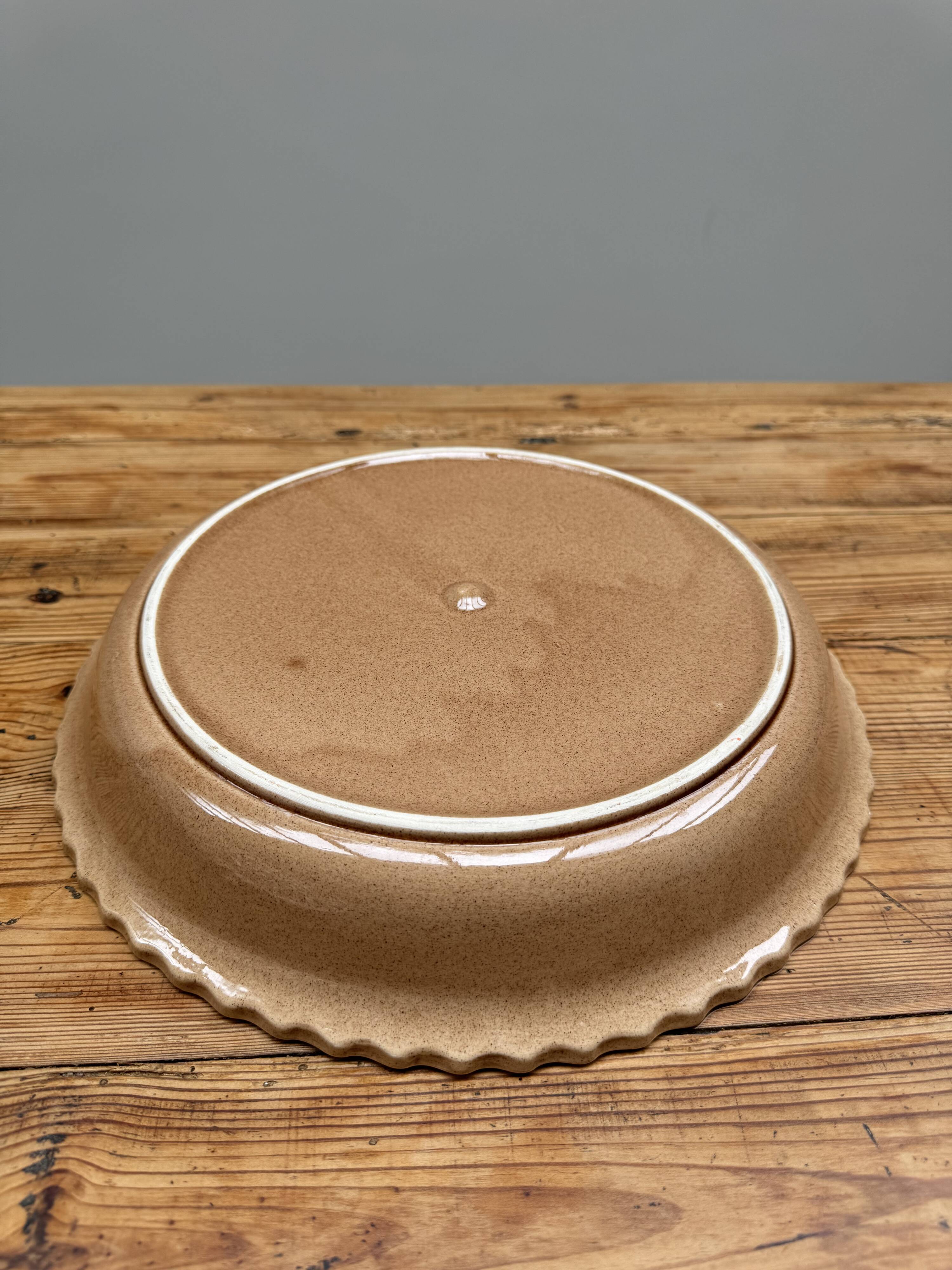 A trompe l’oeil strawberry pie dish
