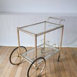 Serving table in gilded metal and glass with large wheels 1950
