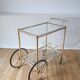 Serving table in gilded metal and glass with large wheels 1950