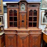 Antique rococo sideboard with integrated clock.