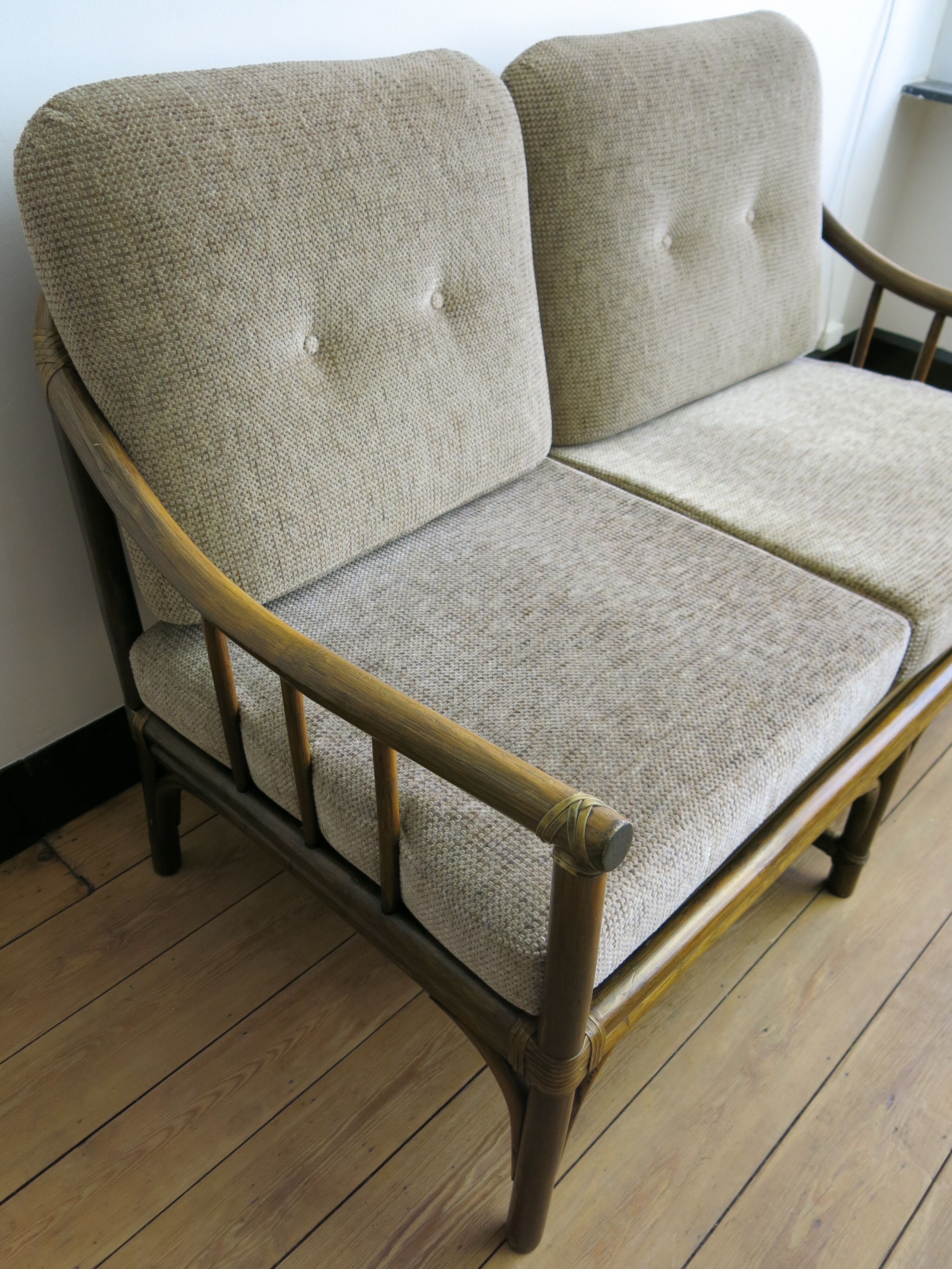 Two-seater rattan sofa with natural tones