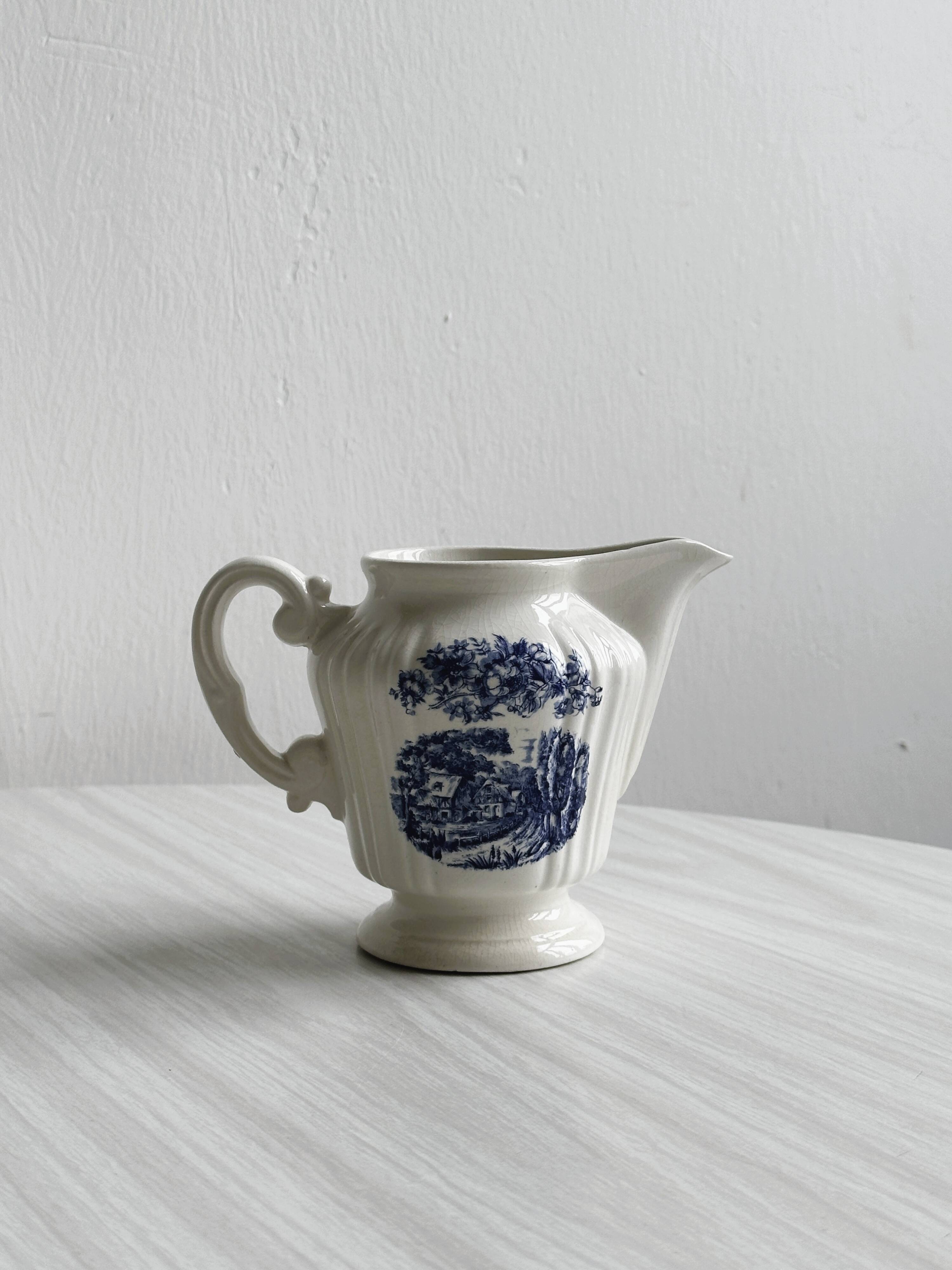 Porcelain sauce boat with blue pastoral pattern