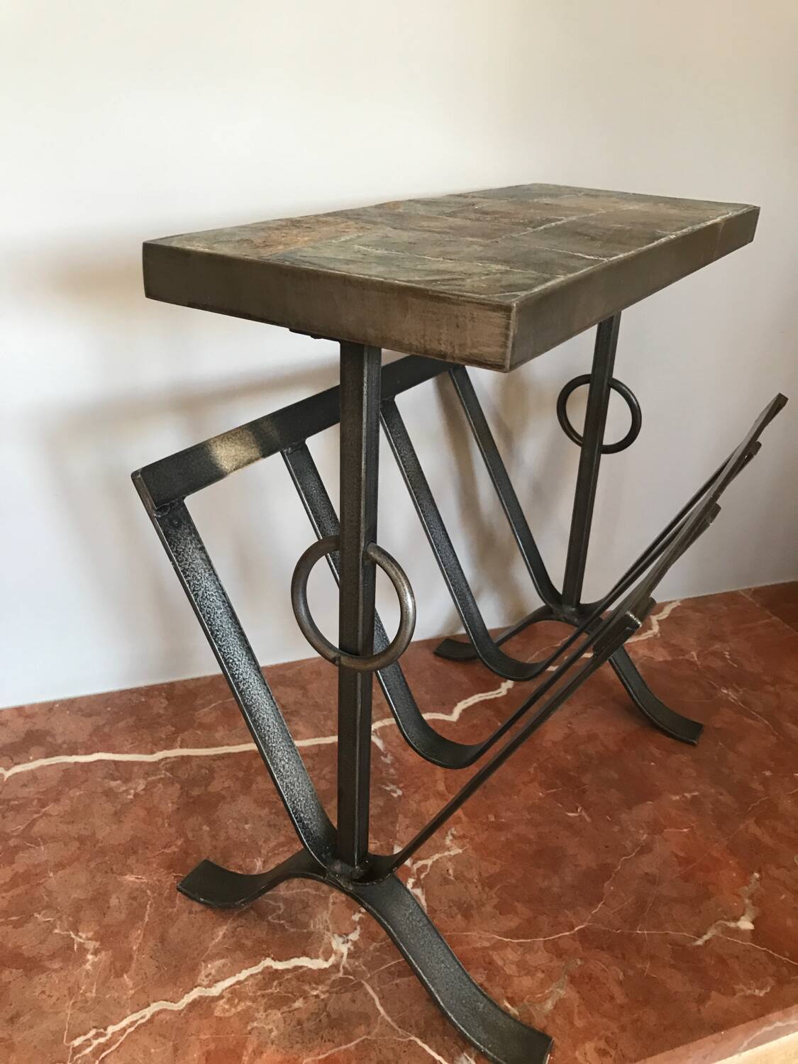 Iron and stone brutalist magazine rack