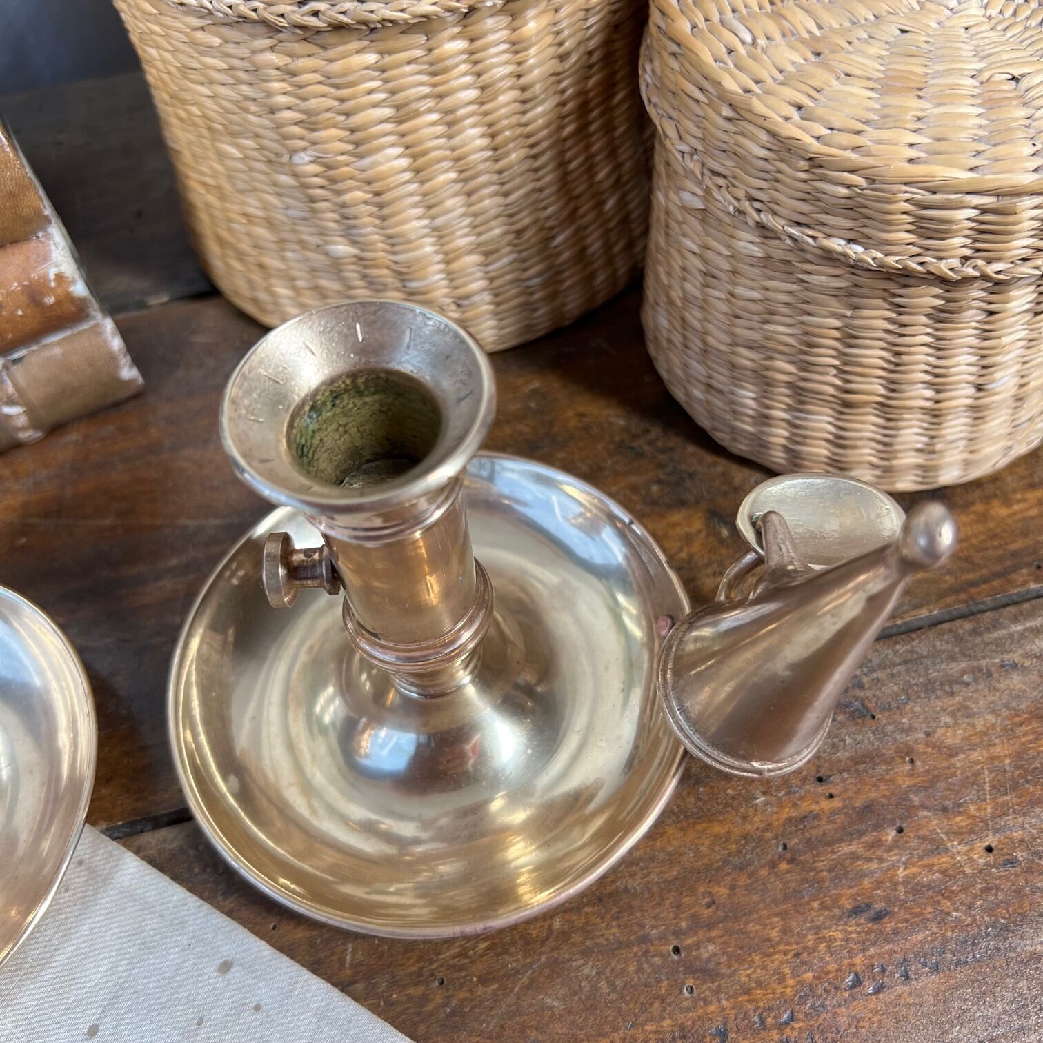 Duo of brass cellar rat candlesticks with extinguisher