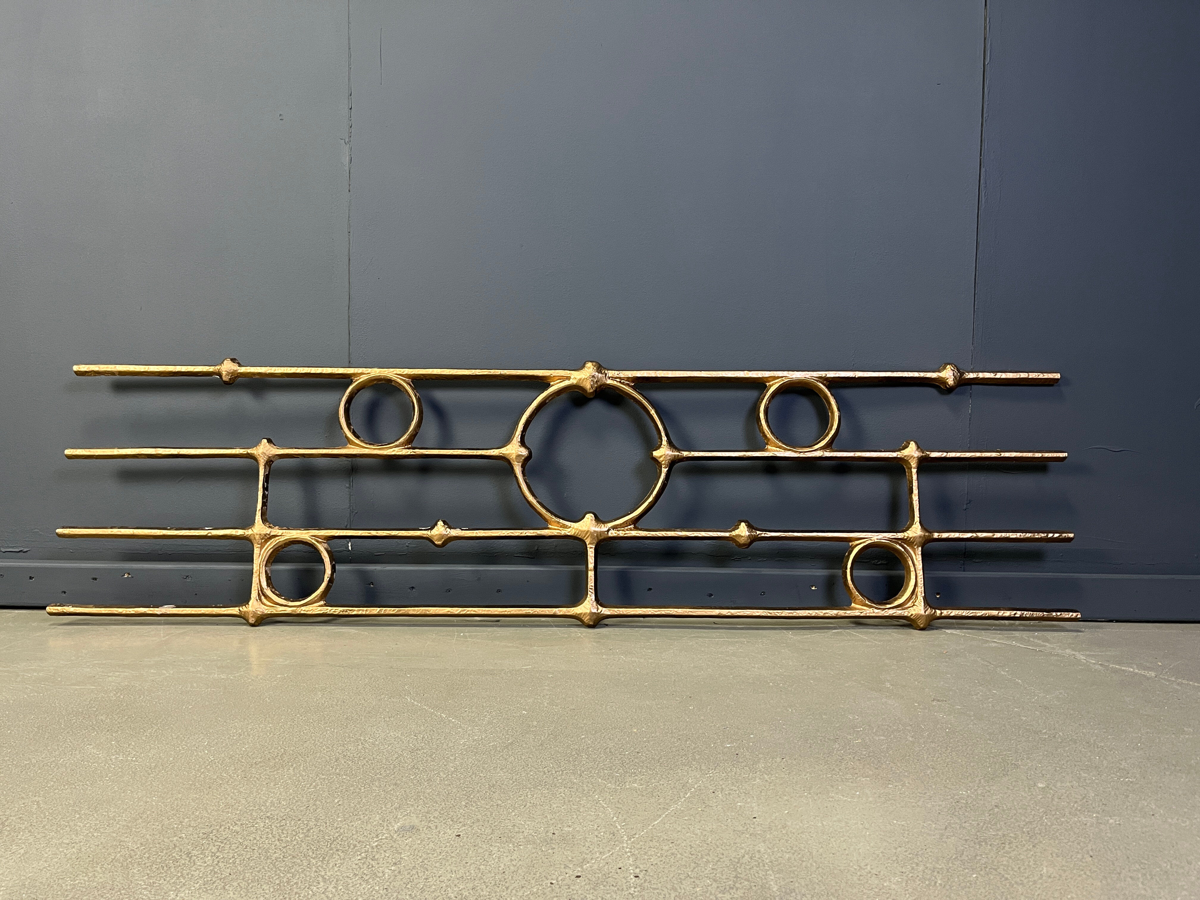 Architectural brutalist wall mounted sculpture made from cast metal.