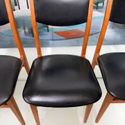 4 Scandinavian chairs in teak and black faux leather.