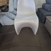 10 white chairs in the style of Verner Panton