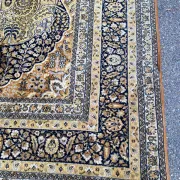 Large Persian wool rug 250x350 cm in gold and navy blue.
