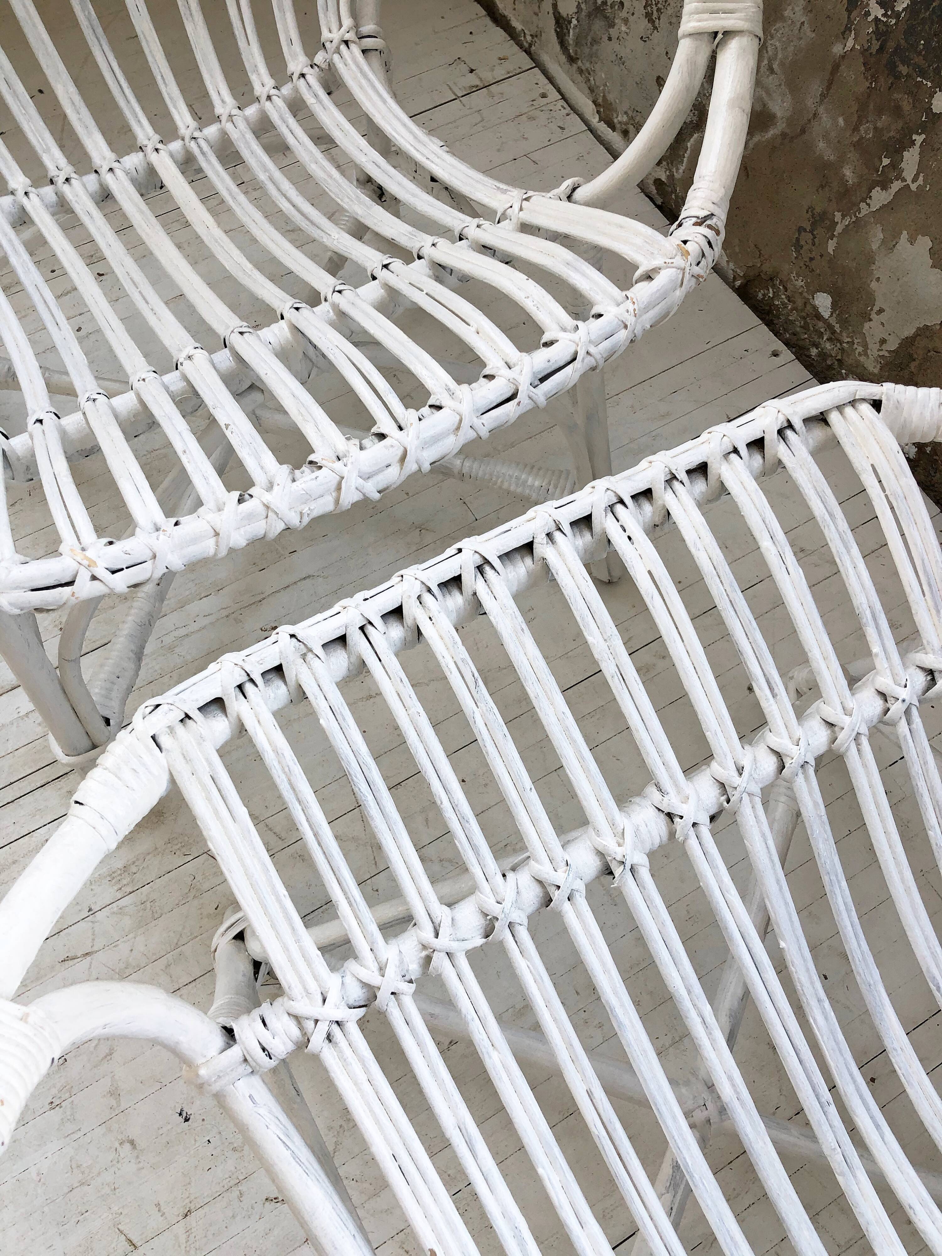 Pair of white rotin armchairs