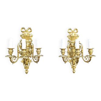 Pair of antique bronze wall sconces from the Napoleonic III era in the Louis XVI style.
