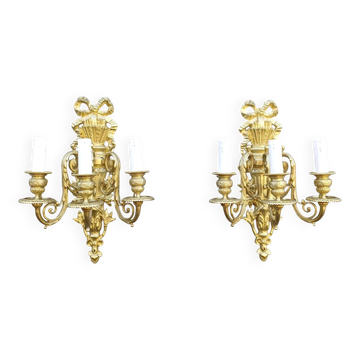 Pair of antique bronze wall sconces from the Napoleonic III era in the Louis XVI style.