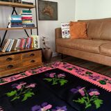 Oltenian floral rug handwoven in wool, purple flowers on black and pink background