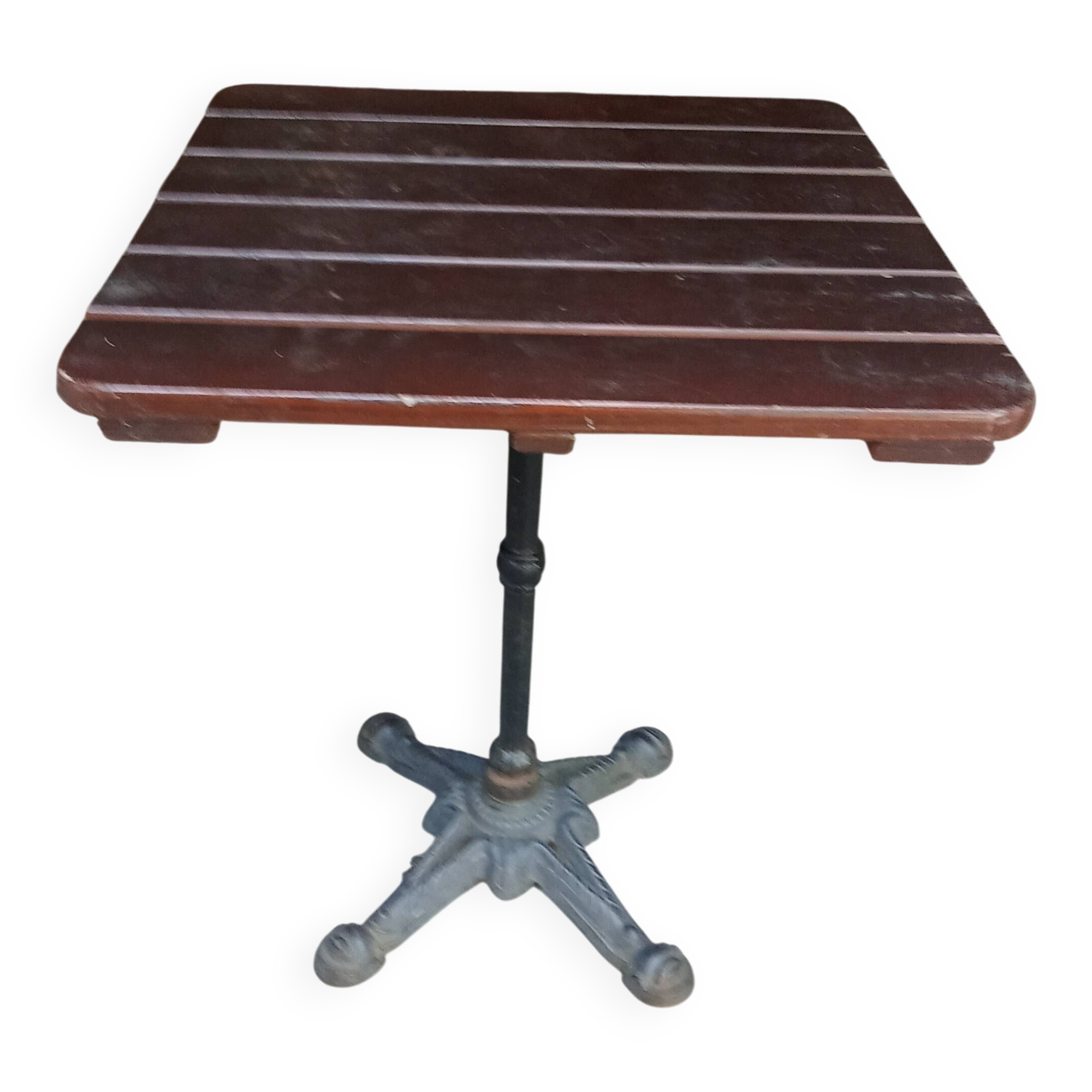Bistro table with a cast iron base and a wooden top.