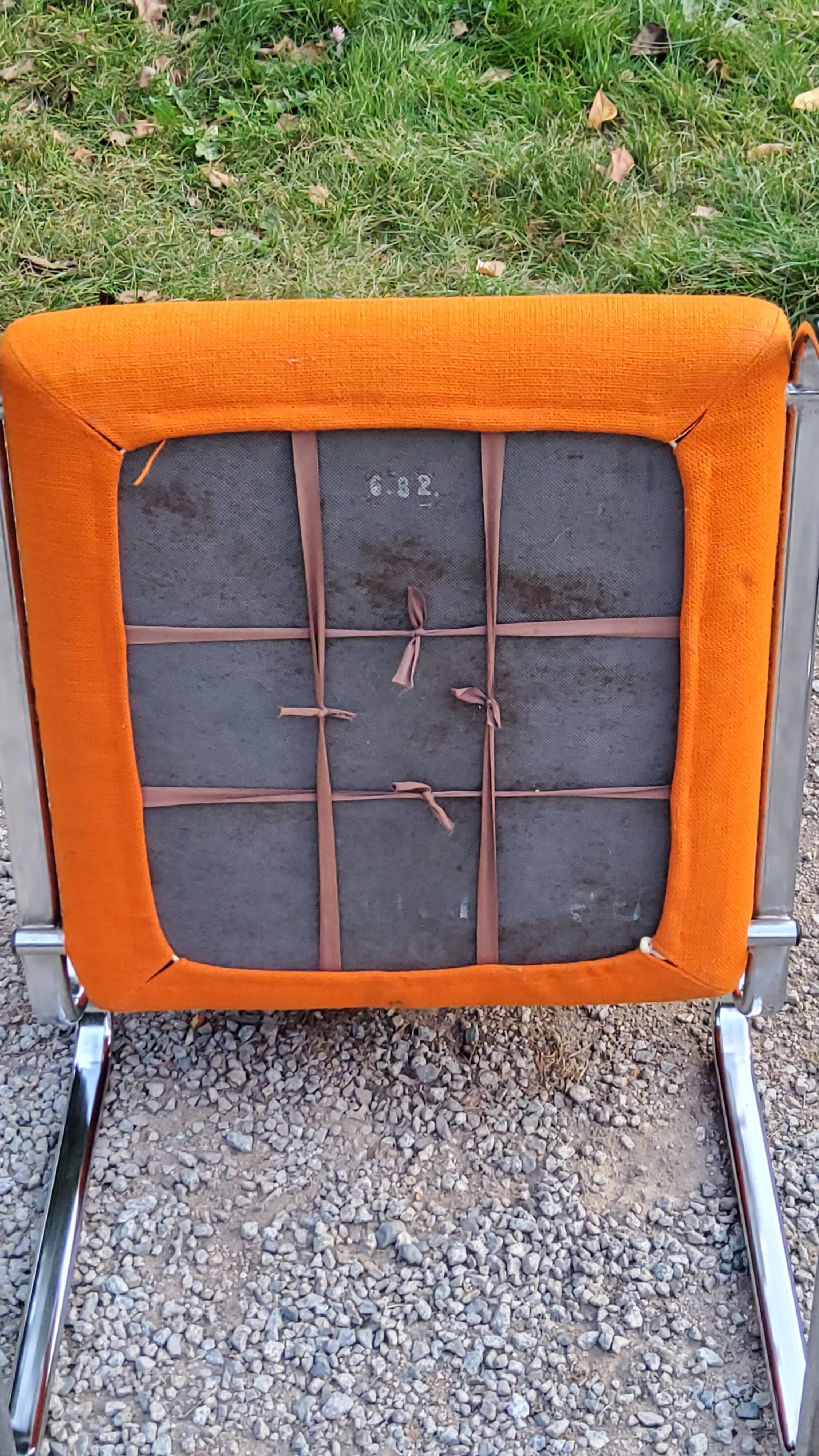 Pair of designer armchairs in orange fabrics and chrome tubes from the 70s