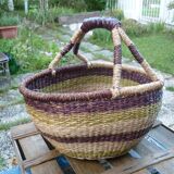 Round and colorful straw basket with handles