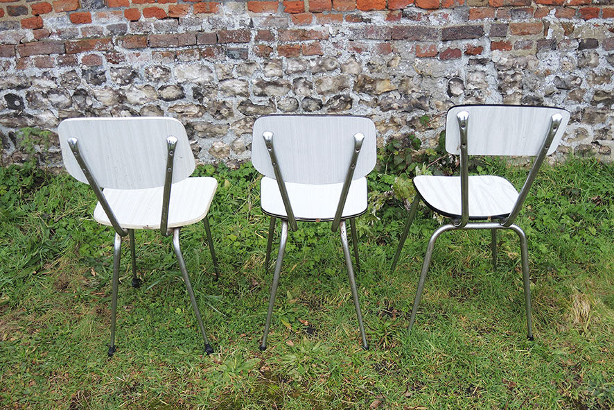 3 old white Formica chairs