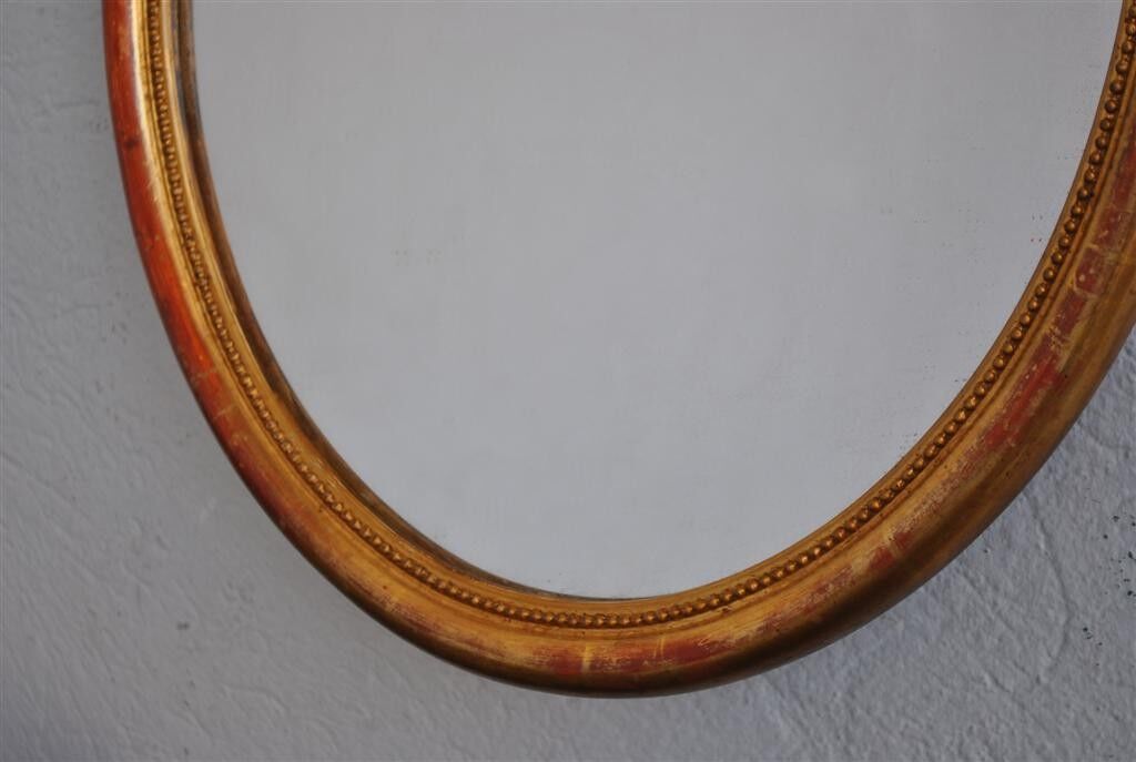 Golden stucco oval mirror