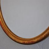 Golden stucco oval mirror