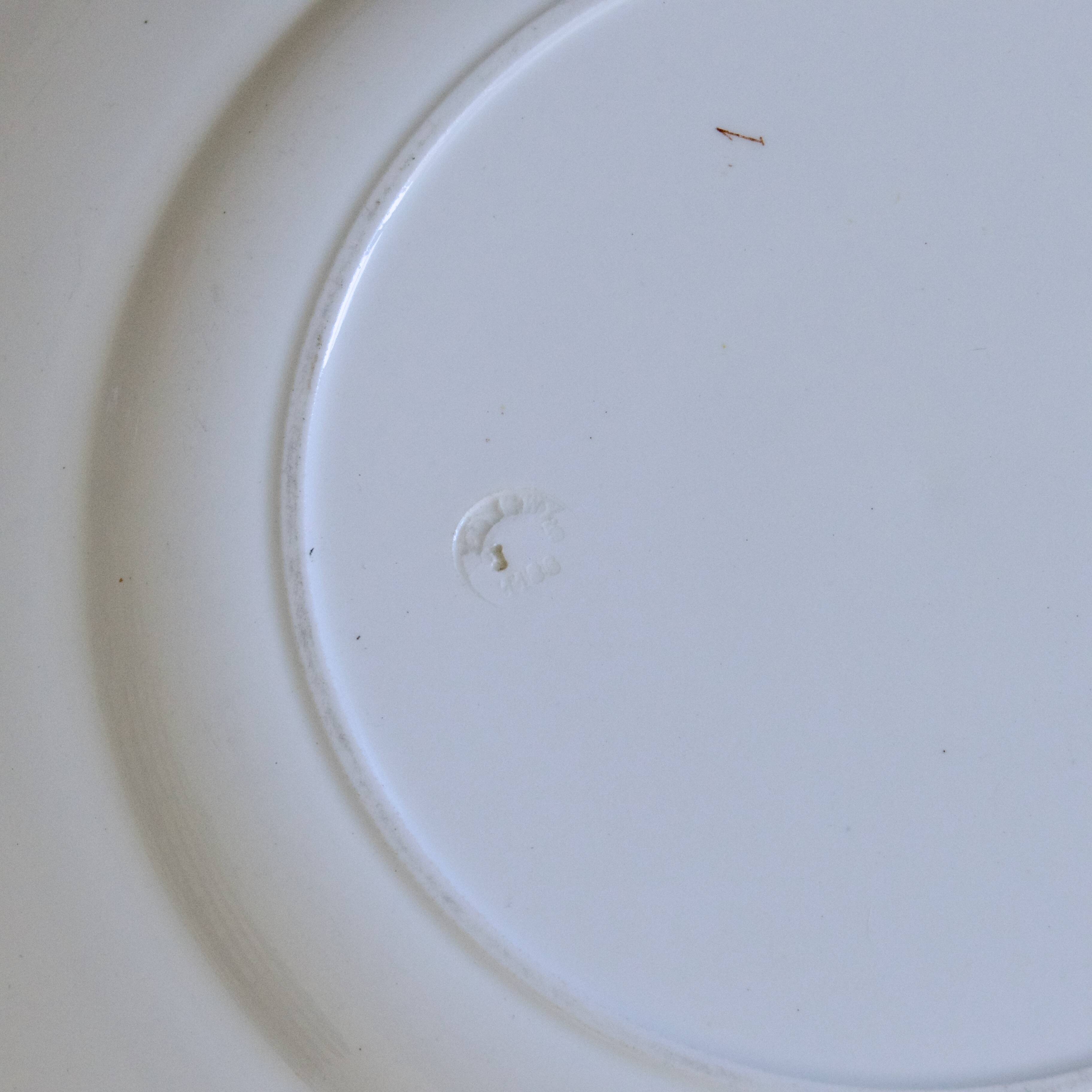 Large round dish from around 1870 signed Longwy with birds in sepia ironstone.