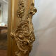 Large antique baroque mirror with angel decorations.
