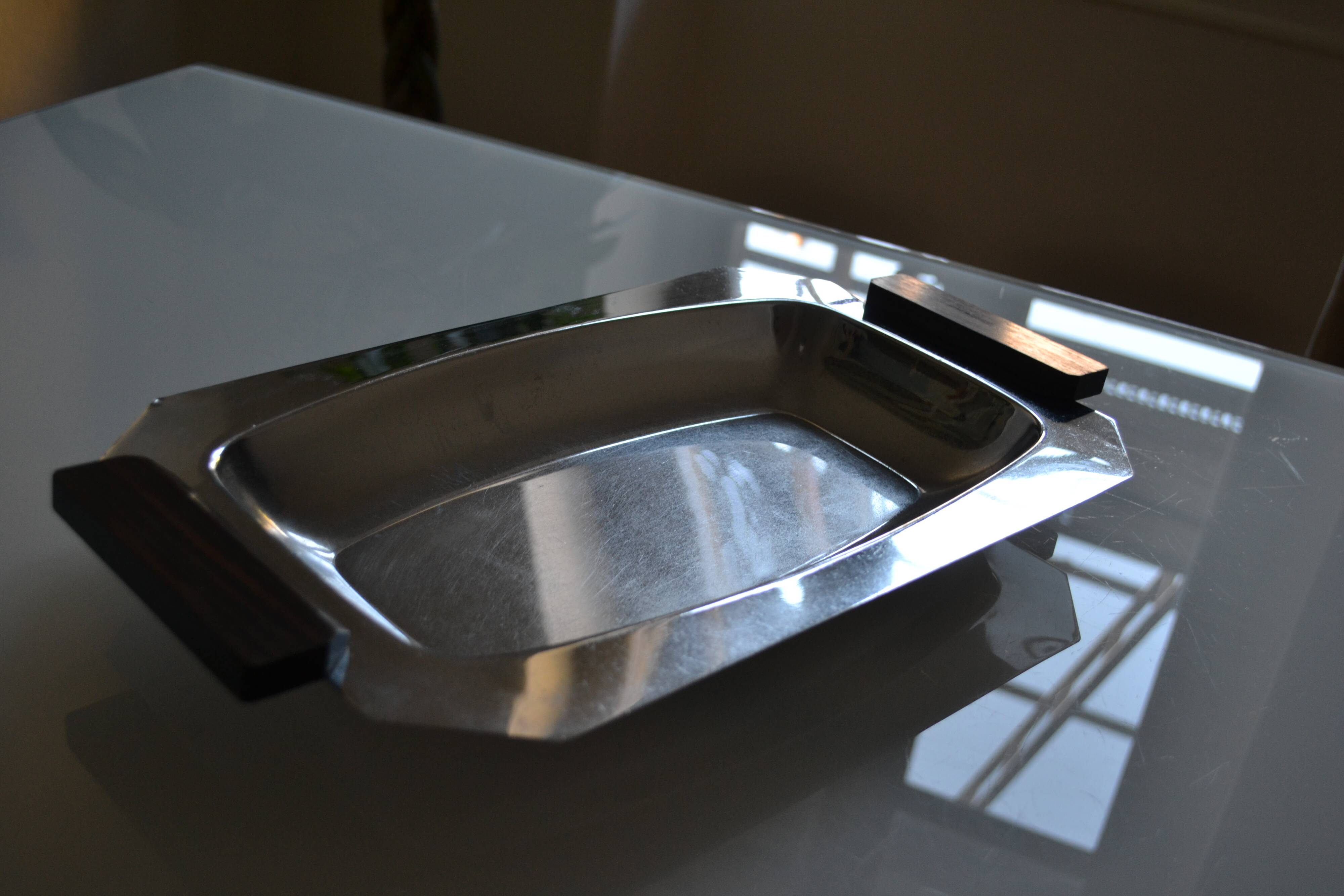 Art Deco serving dish in chrome metal with ebony handles.