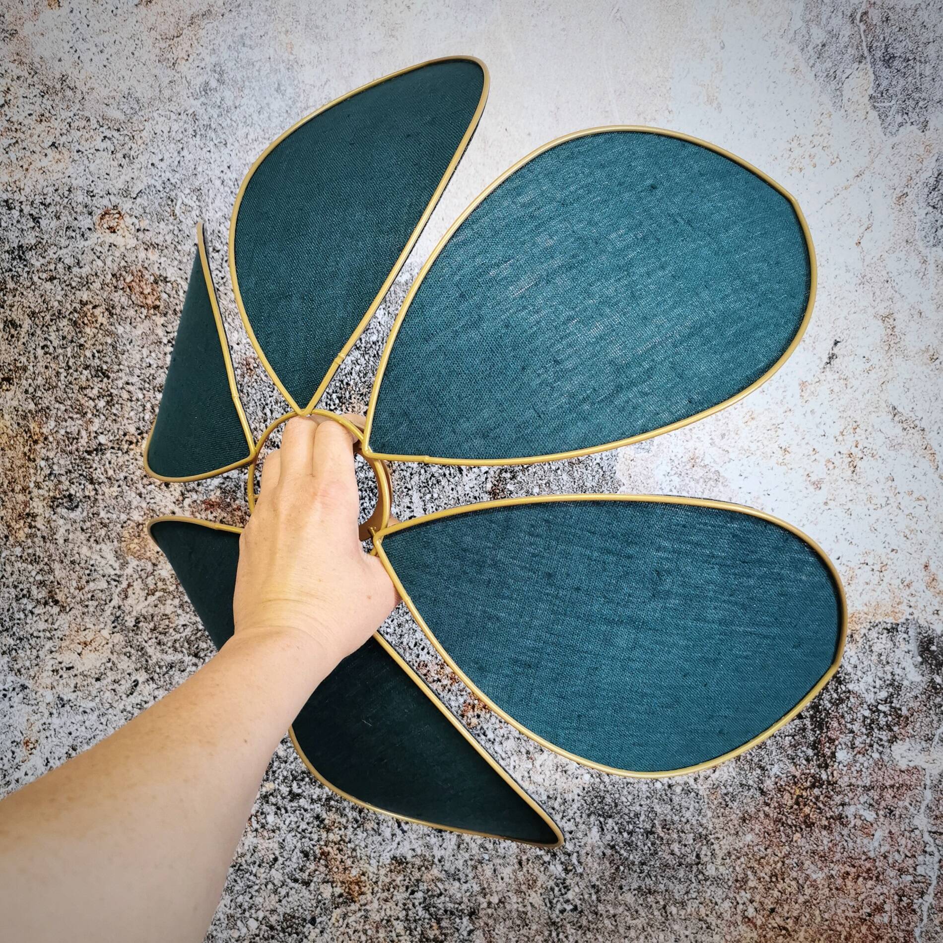 Flower suspension with metal structure and peacock blue linen petals