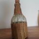 Bottle dressed in woven wicker