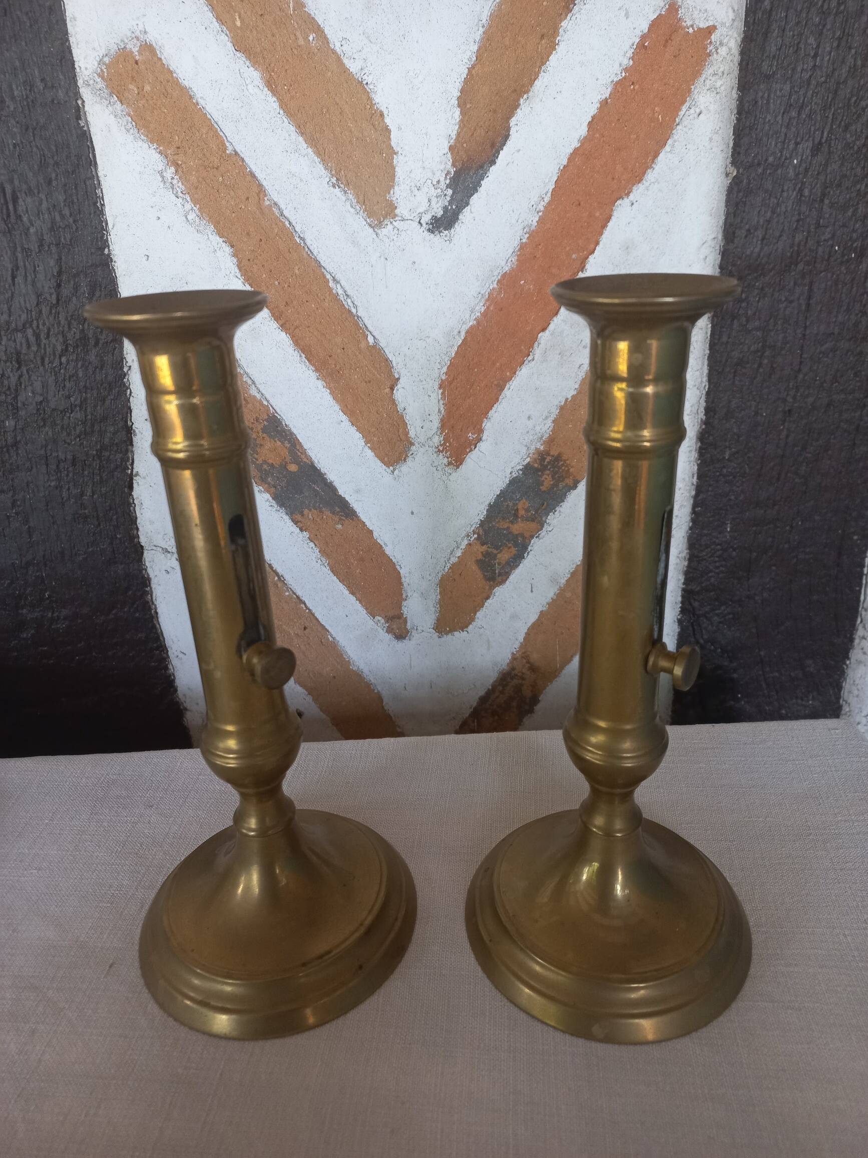 Pair of brass push-button candlesticks