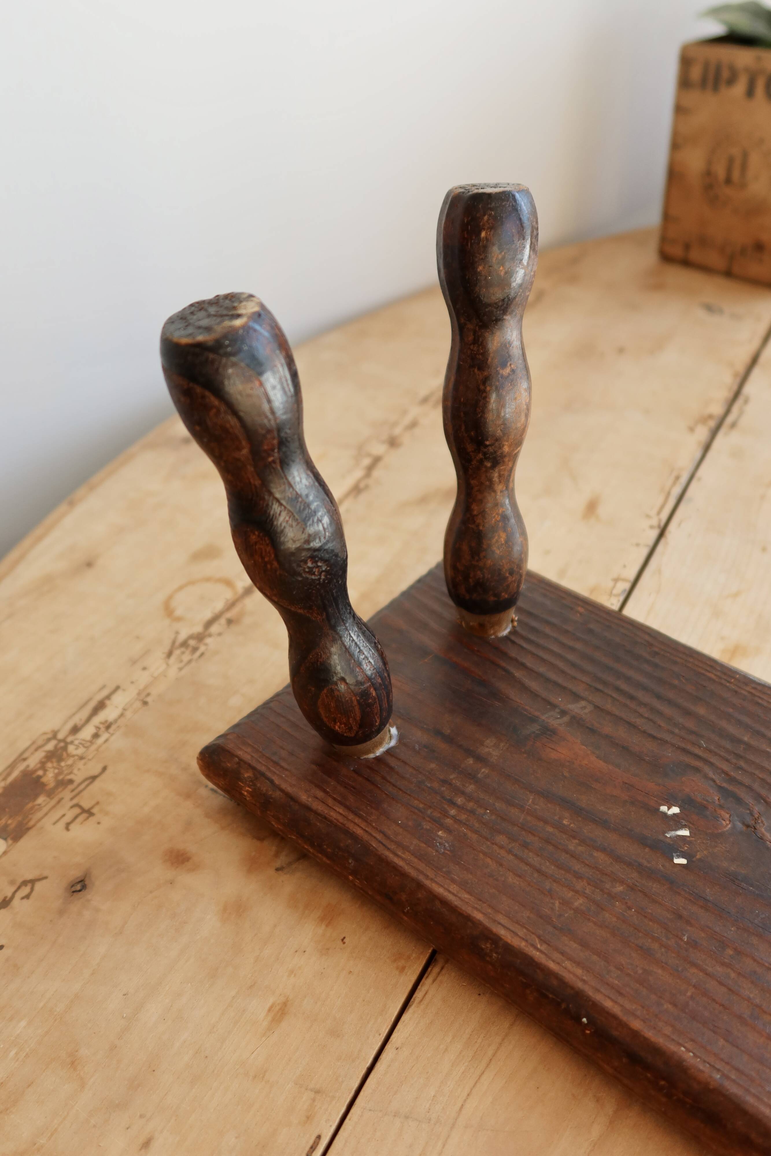 Vintage rectangular stool in dark wood with turned legs.