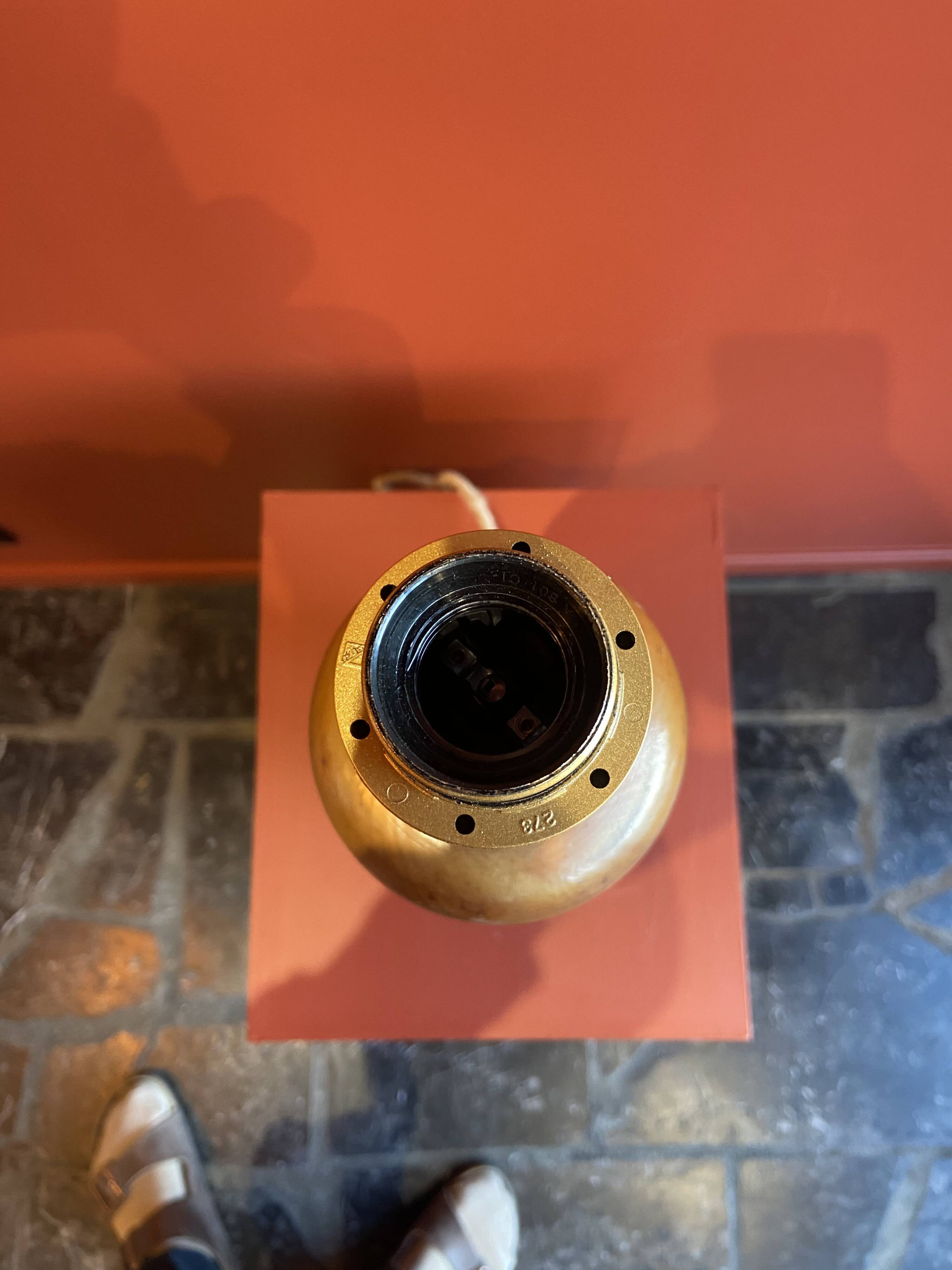 "Stoneware Bottle Lamp" with a multicoloured blue lampshade handwoven in India.