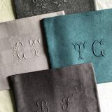 Set of four old damasked and monogrammed towels, tinted multiple colors