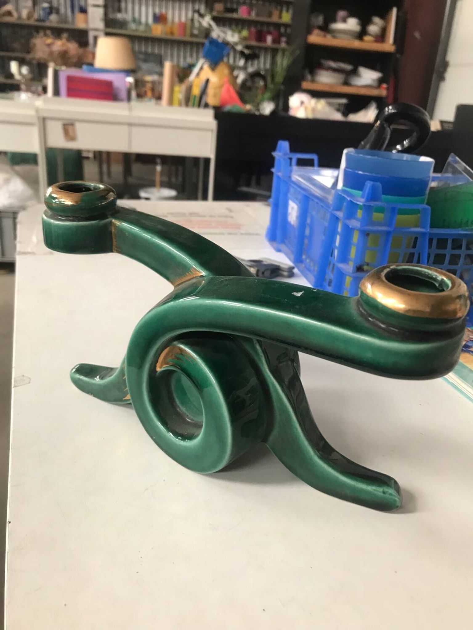 Art Deco candlestick in green and gold earthenware.