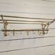 Wall-mounted coat rack with brass hat rack