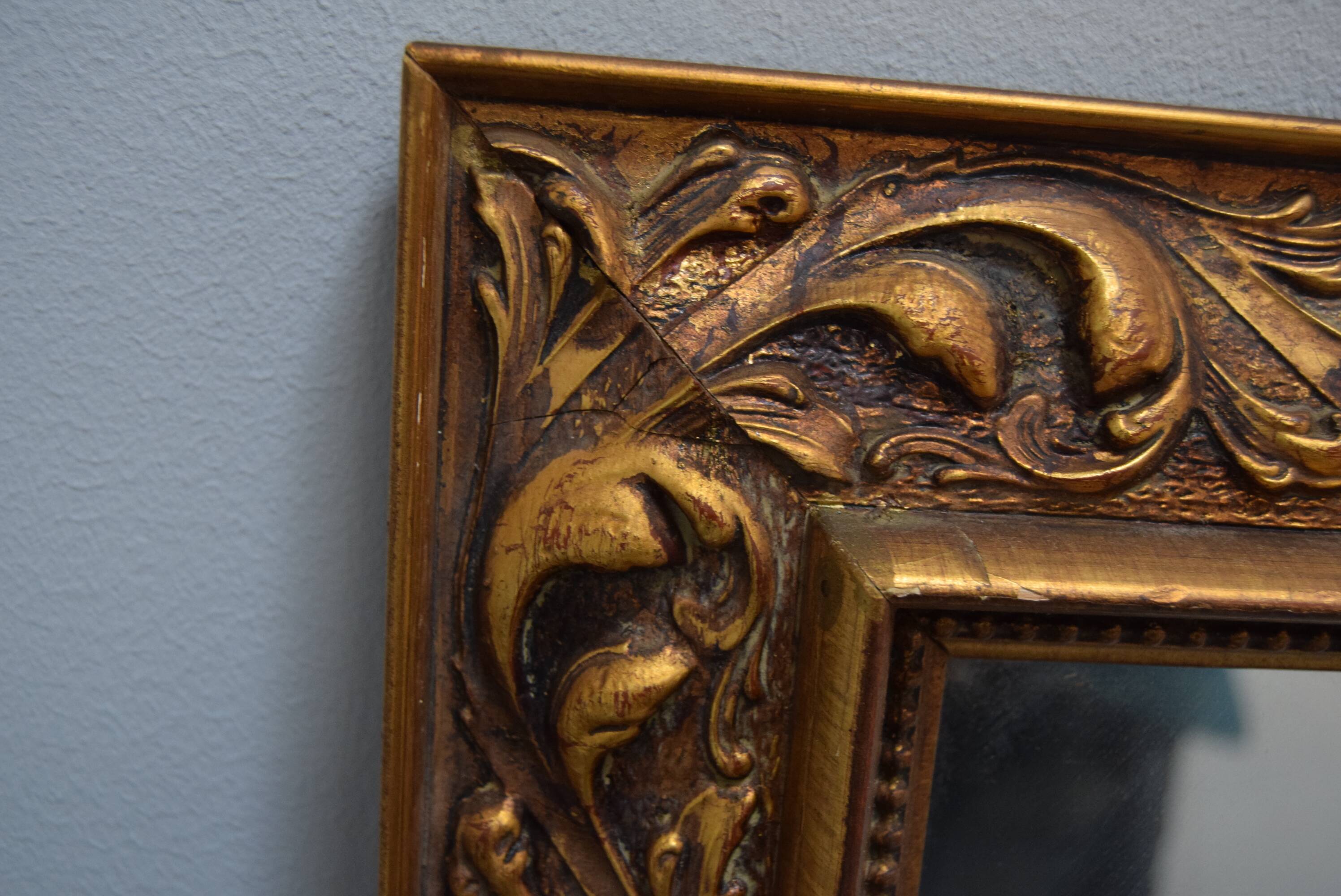 wall mirror in a decorative wooden frame.