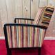 Art Deco armchair in multicolored striped fabric and its footrest