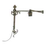 Adjustable wall light in brass and gold metal.