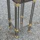 Pair of Hollywood Regency side tables in gold metal and smoked glass.
