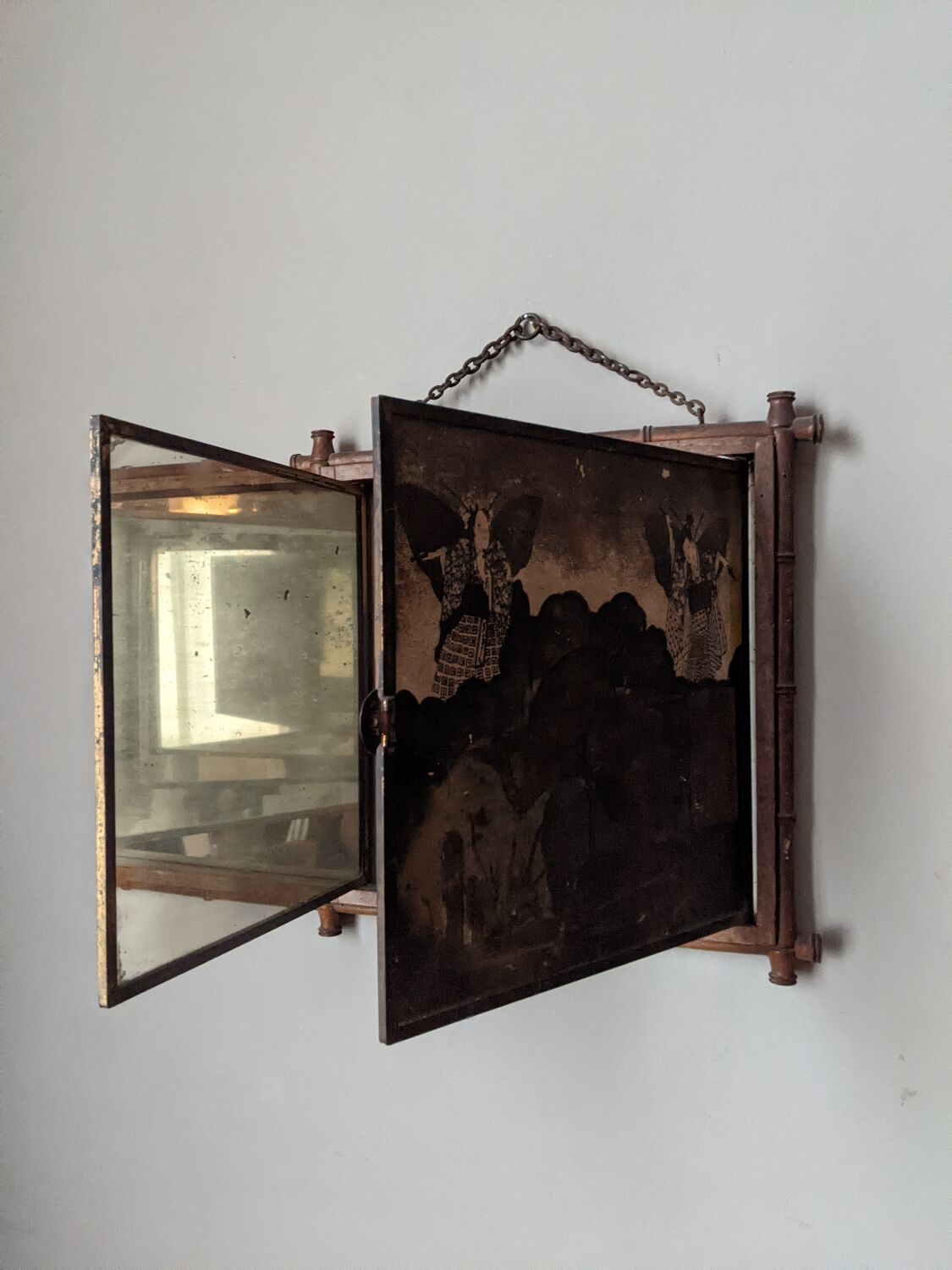 Antique Asian decorative triptych mirror with chain wall decoration in wood.