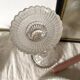 Tall molded glass candle holder with ram heads