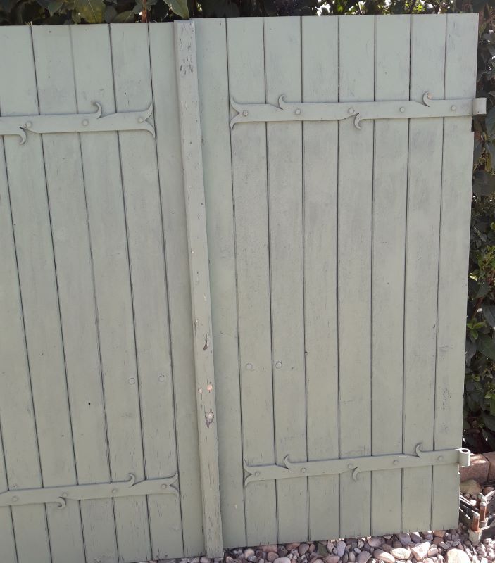 Pair of wooden shutters hanging iron