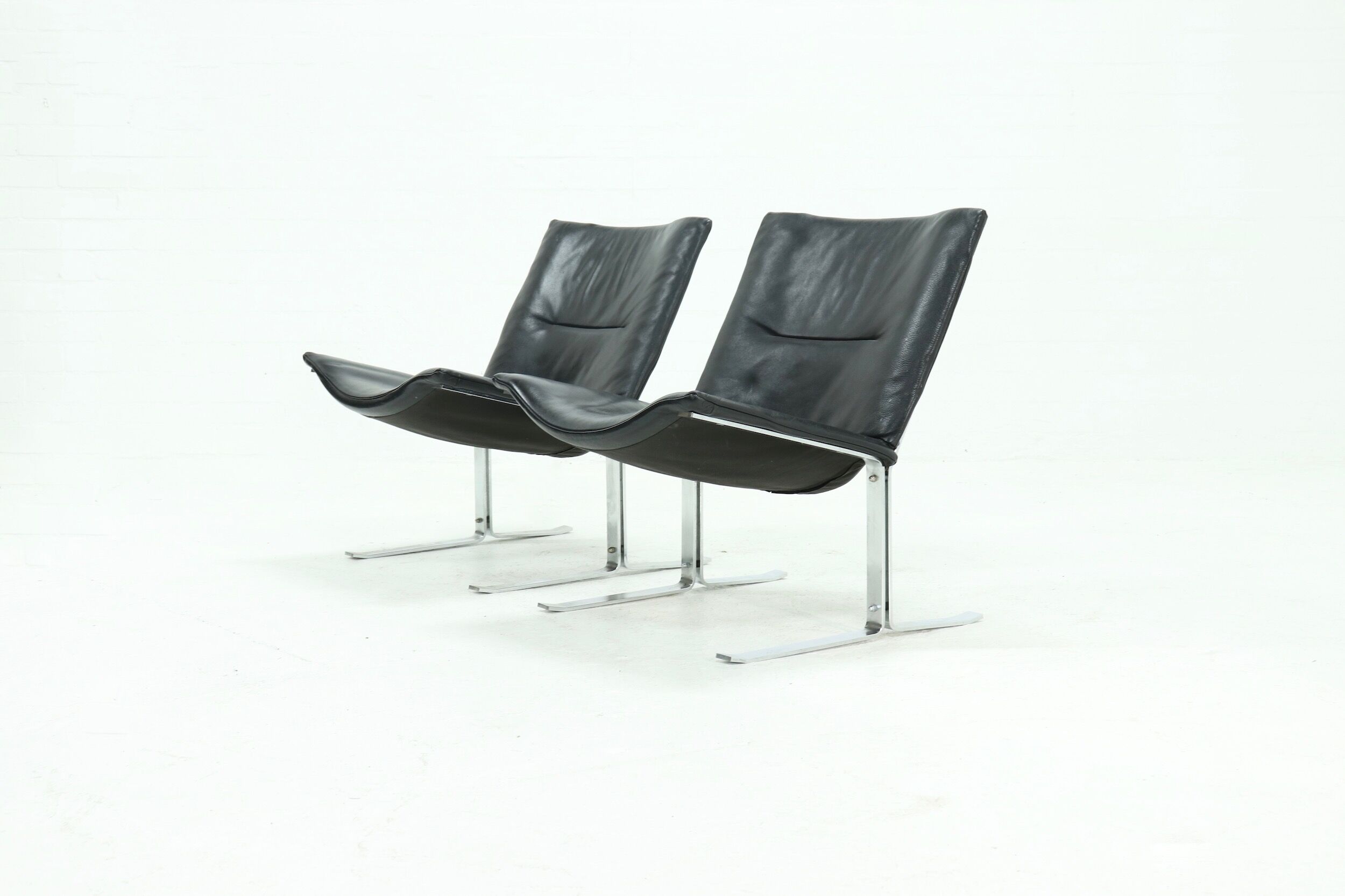 Set of 2 Danish lounge chairs by Kebe Møbler model Eagle with black leather.
