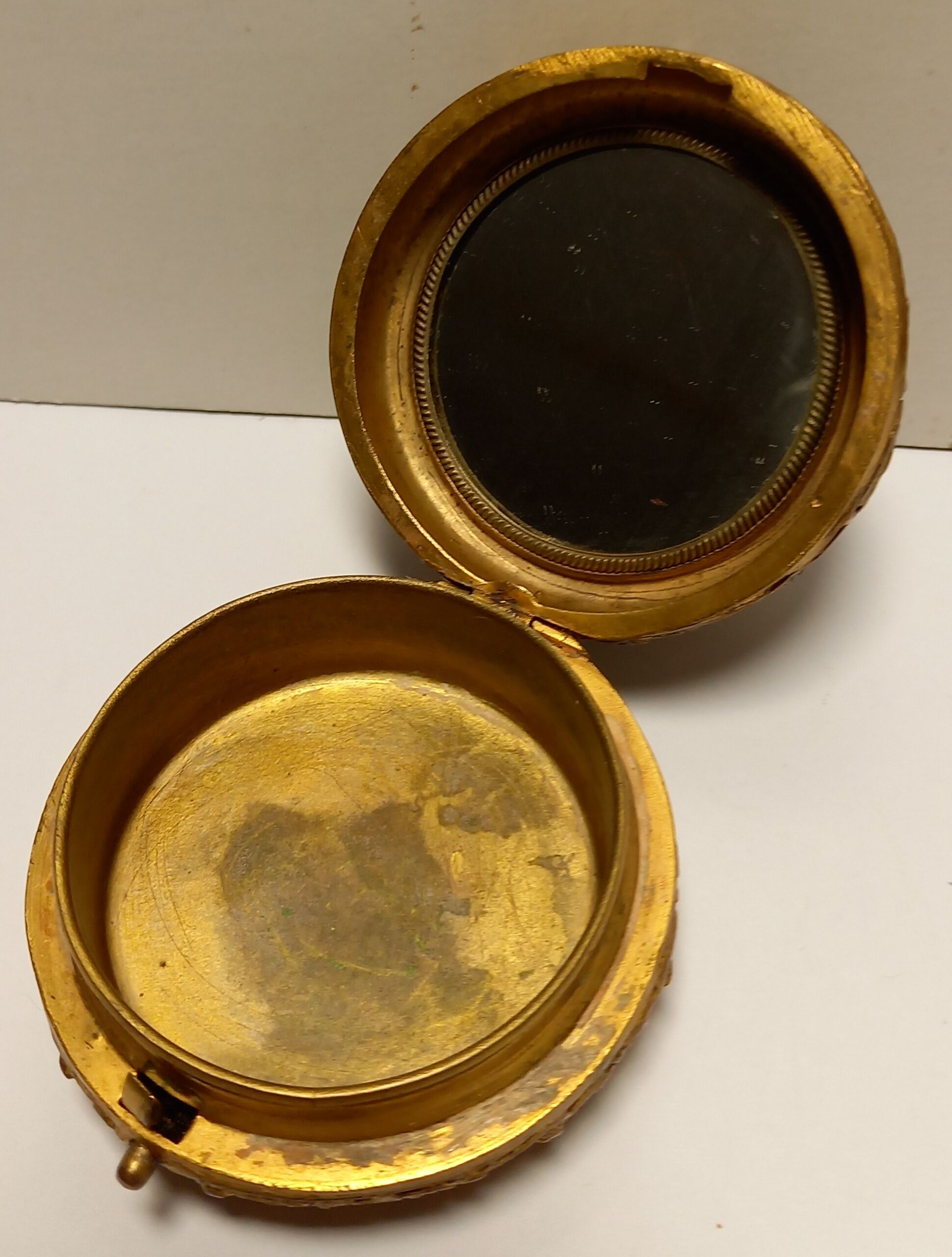 Old brass and copper powder magazine decorated with cherubs