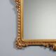 Antique Rococo-style mirror in carved gilded wood, 20th century.