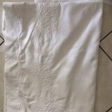 Old sheet with hand made embroidery, shaped flowers.