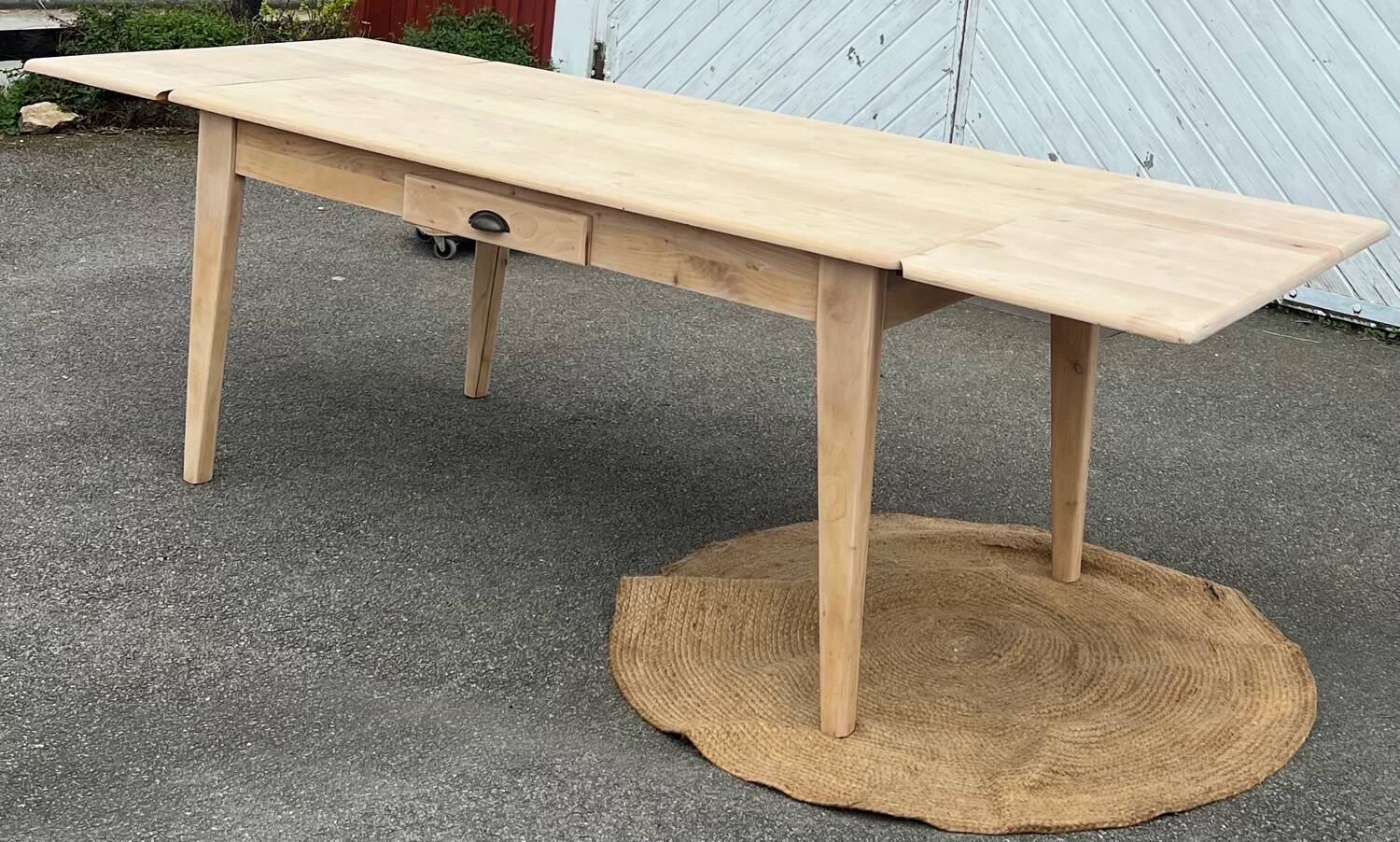 Large renovated table with 2 extensions and 2 drawers in raw solid wood.