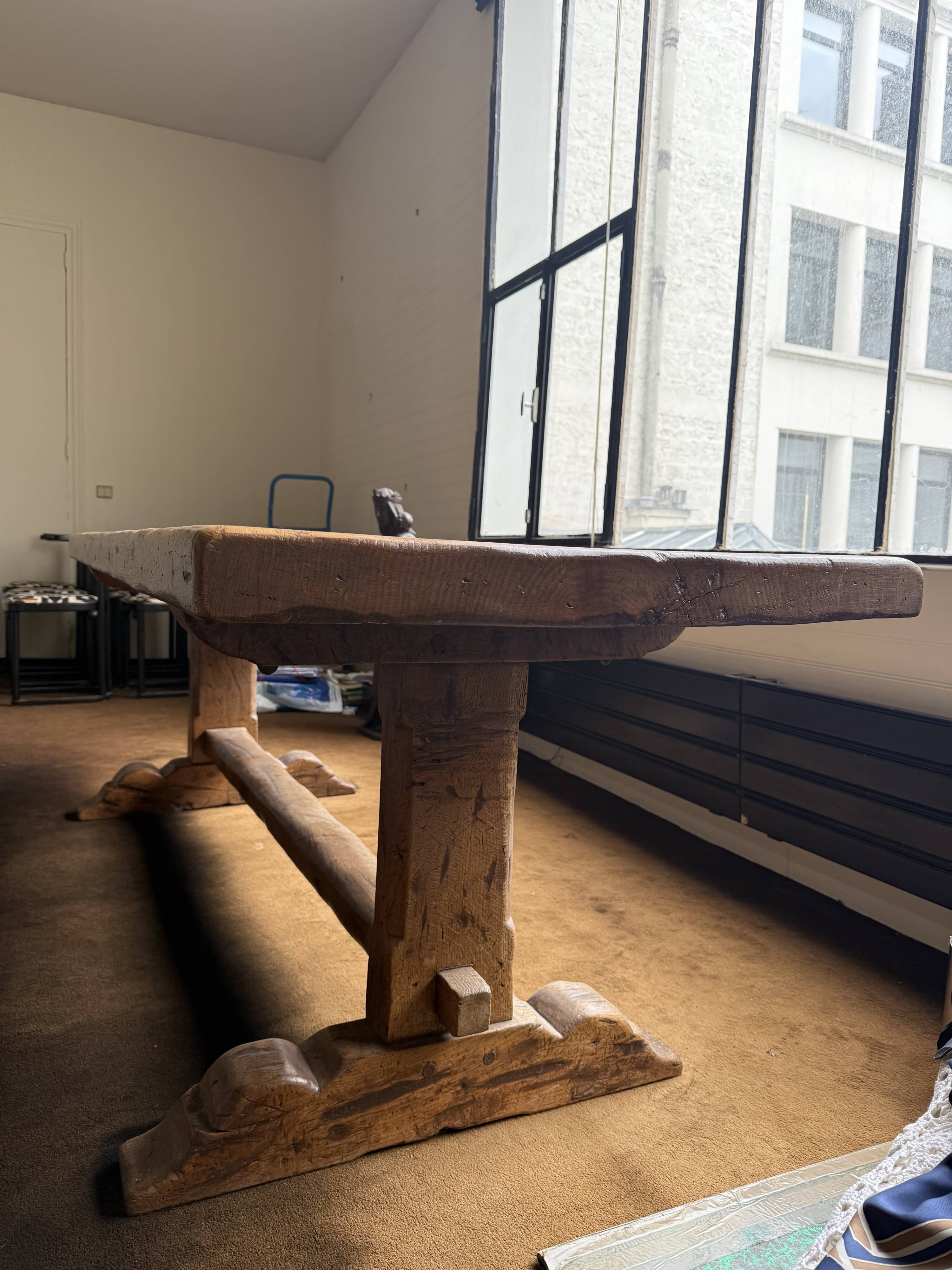 Large antique farmhouse table made of solid wood, in monastery style.