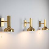 Set of three brass adjustable wall lamps